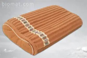 Angled view of BioMat contoured pillow showcasing ribbed texture and neck-support curve on a light gray background