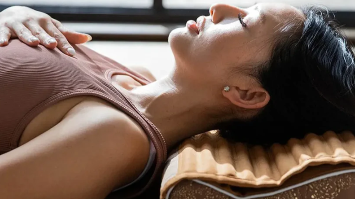 Person lying on a crystal healing mat illustrating negative ion therapy benefits